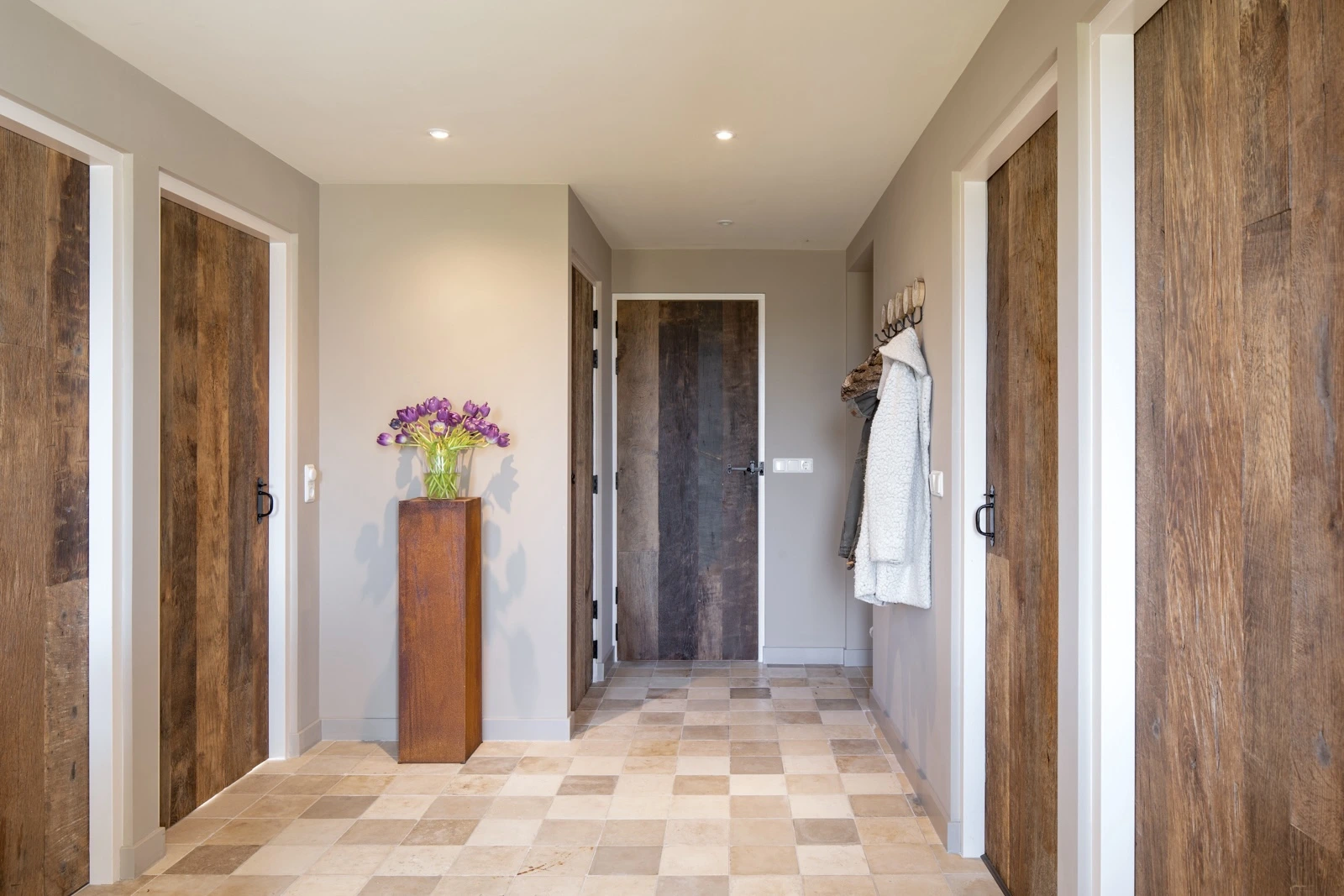 Hallway with solid oak interior doors and natural wood grain in a bright modern interior