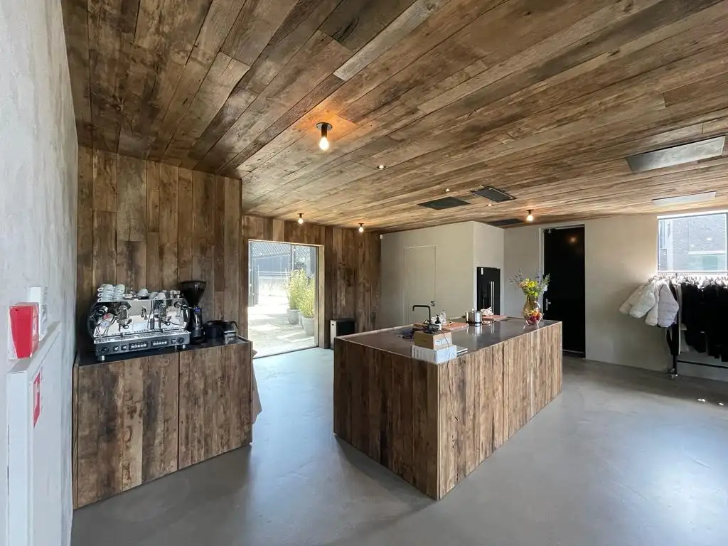 Wooden wall cladding with rustic reclaimed wood textures in a modern kitchen interior