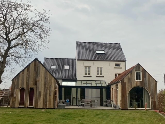 Modern country house with reclaimed wood cladding and rustic architectural details