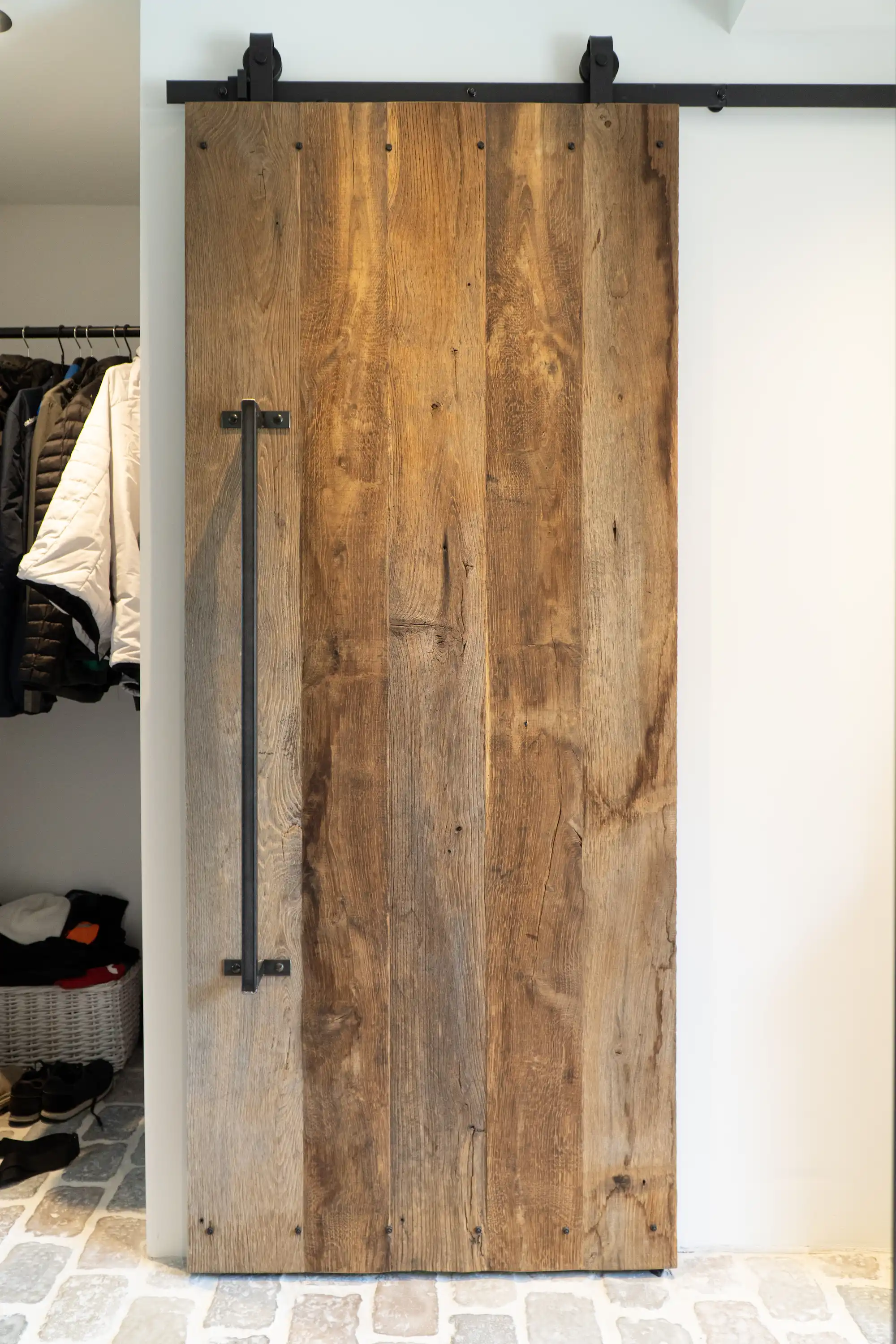 Rustic reclaimed barnwood sliding door perfect for farmhouse-style interiors