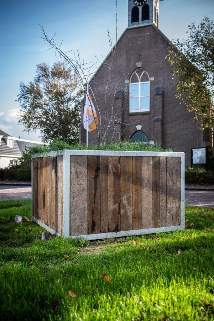 Outdoor storage unit clad with reclaimed Azobé ship planks and weathered wood textures