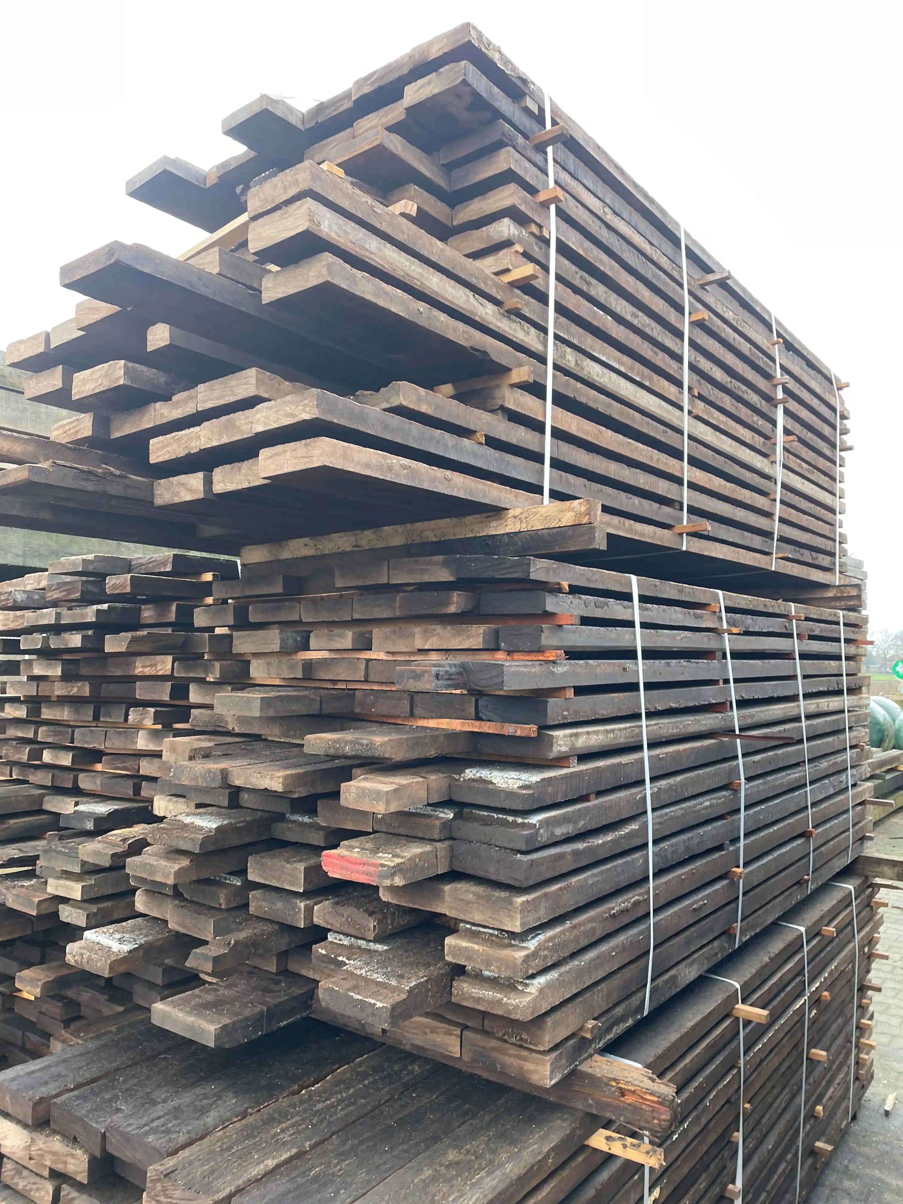 Premium reclaimed timber stacked for storage with natural imperfections and vintage character