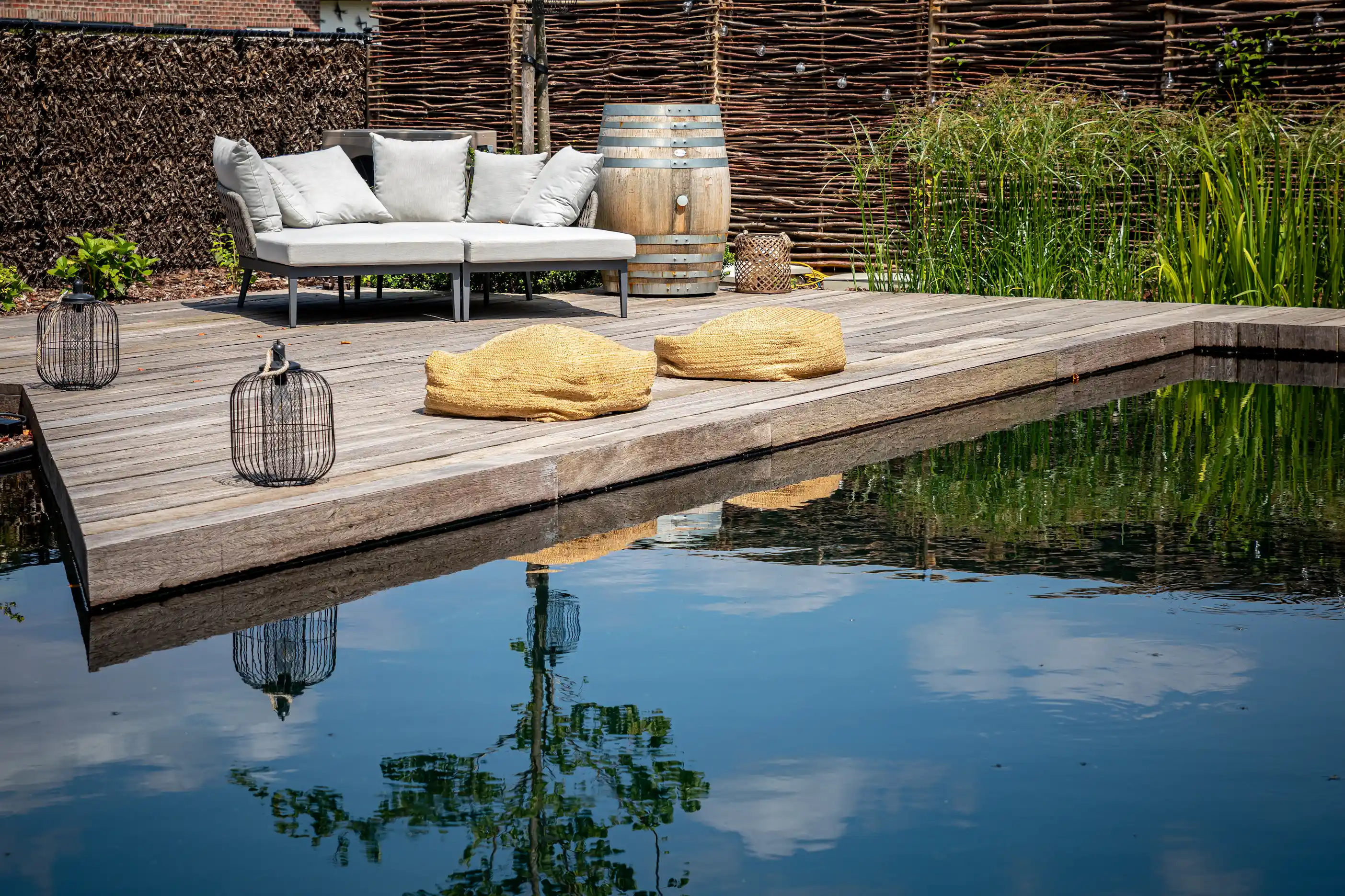Reclaimed timber decking surrounding a modern swimming pool with warm natural wood tones