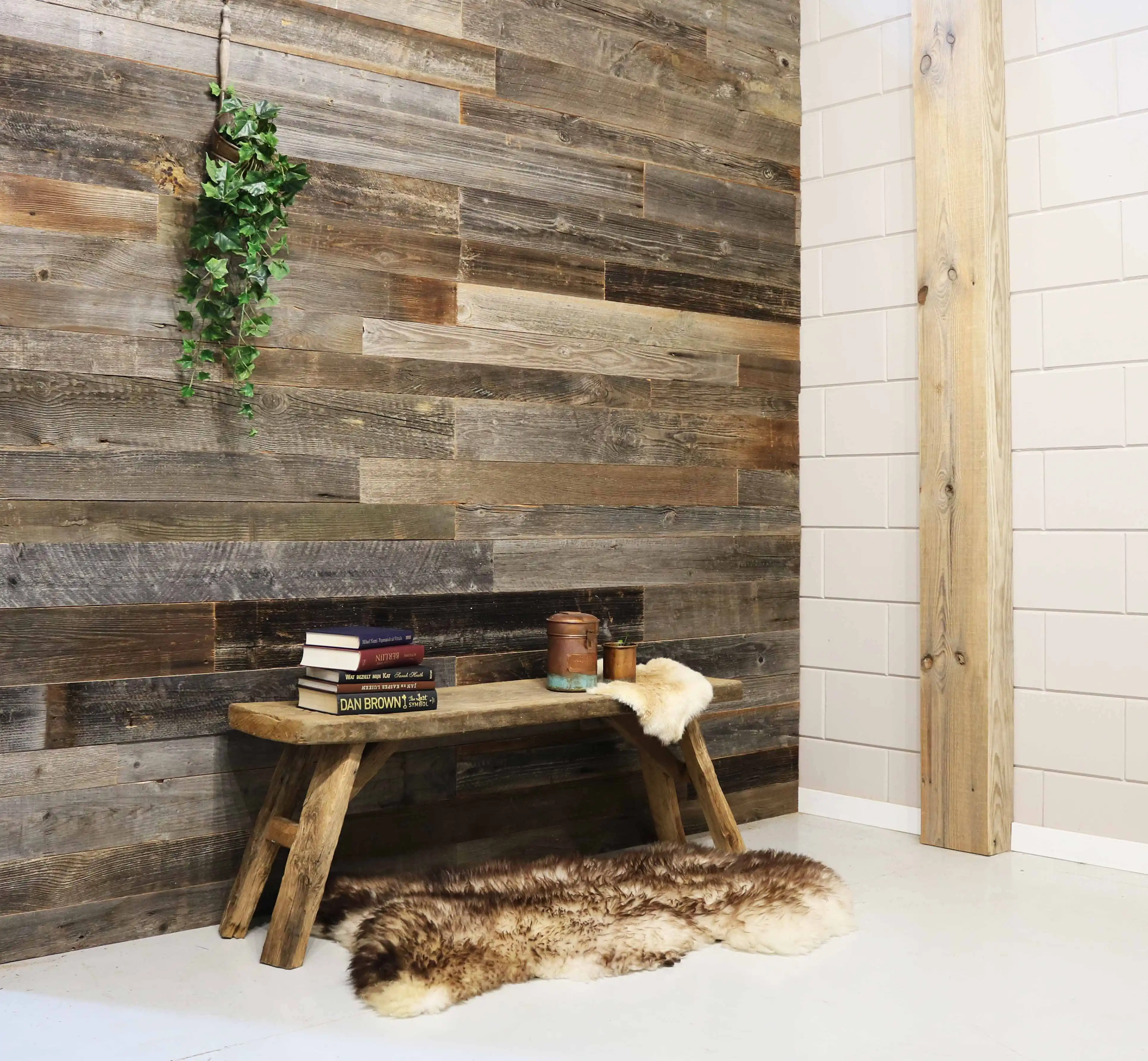 Interior wall finished with alpine reclaimed wood panels and rustic wooden bench.