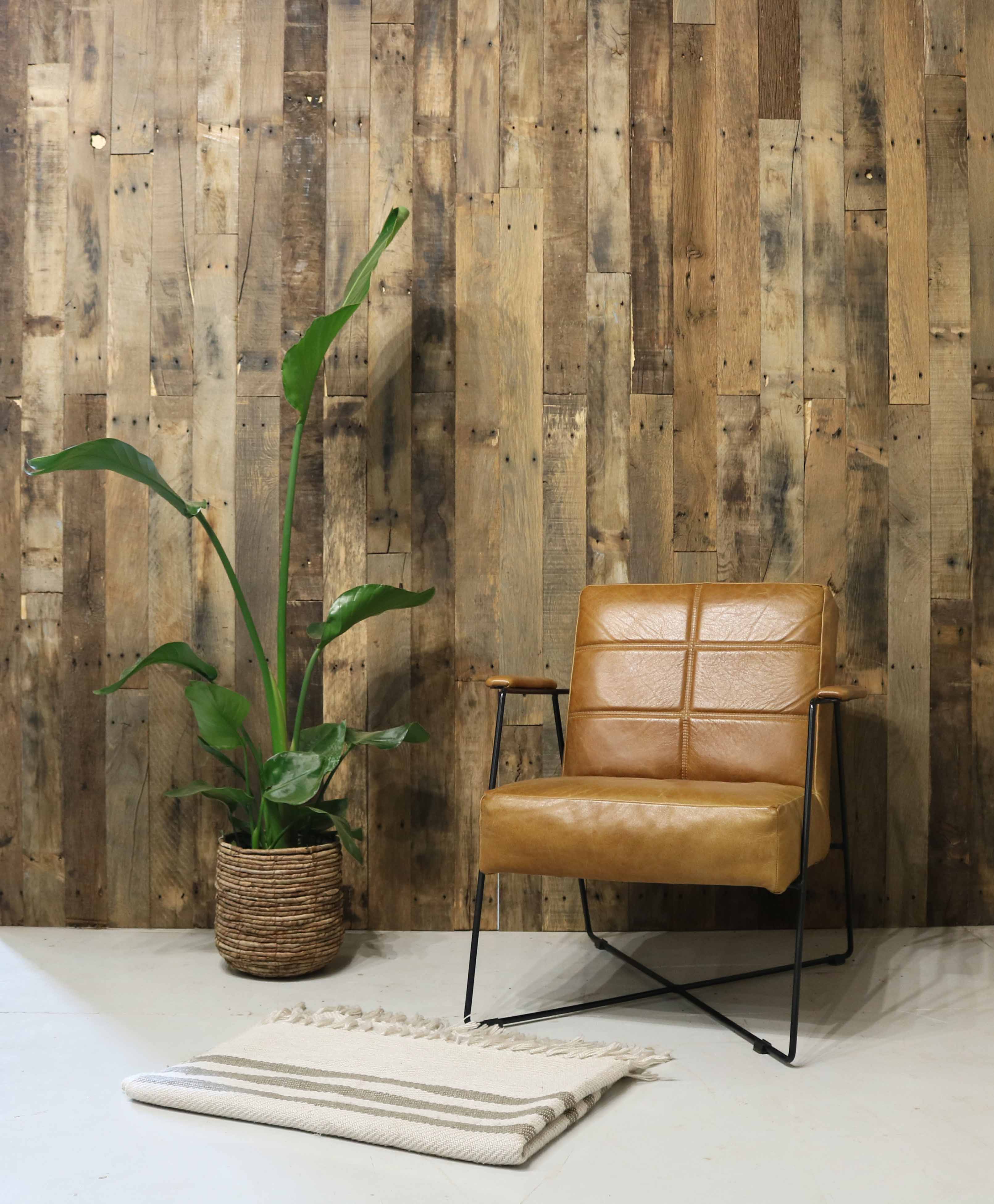 Rustic wooden wall cladding with natural aged wood textures in a stylish interior setting