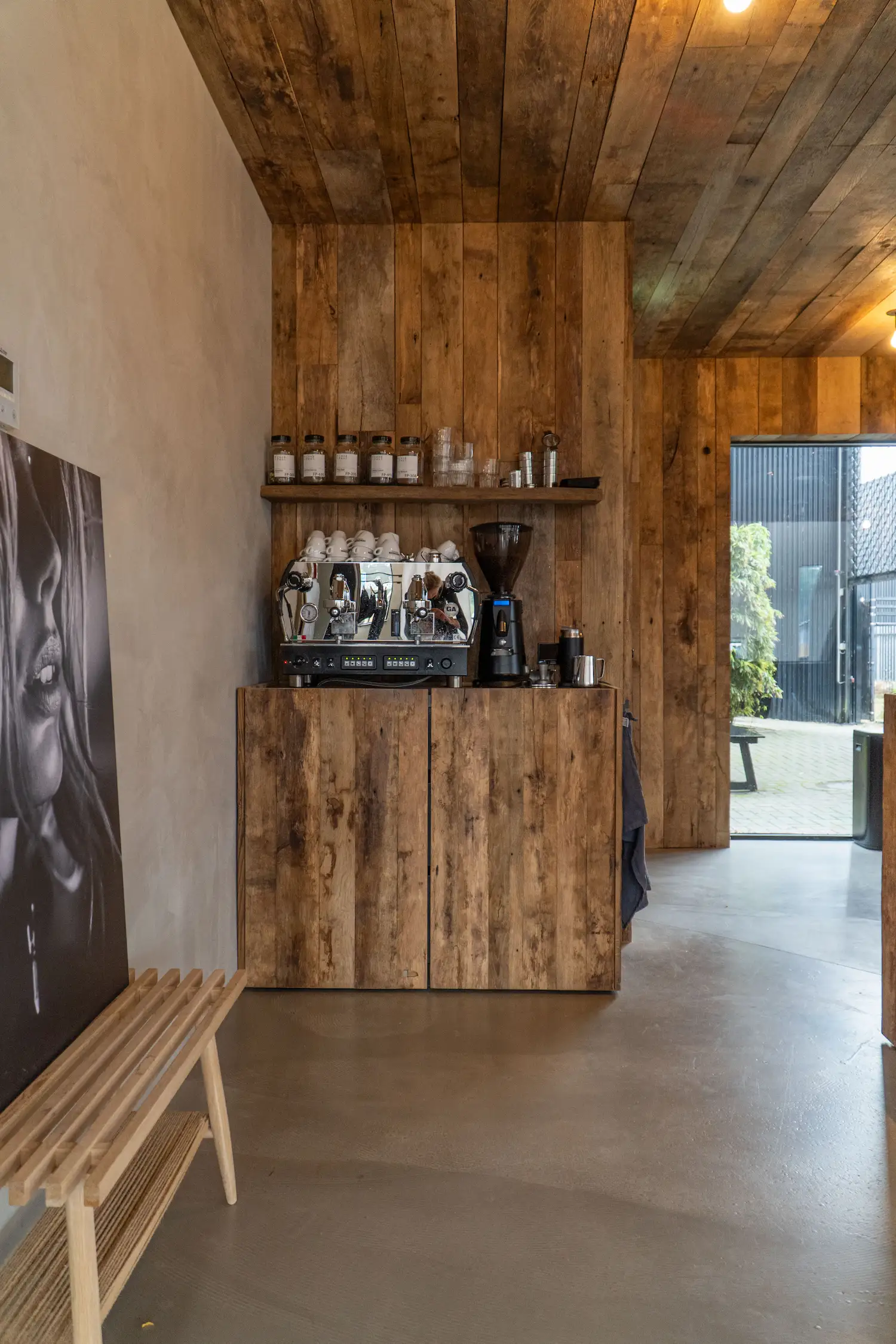 Interior with reclaimed wood cabinet doors and weathered timber ceiling creating a warm atmosphere