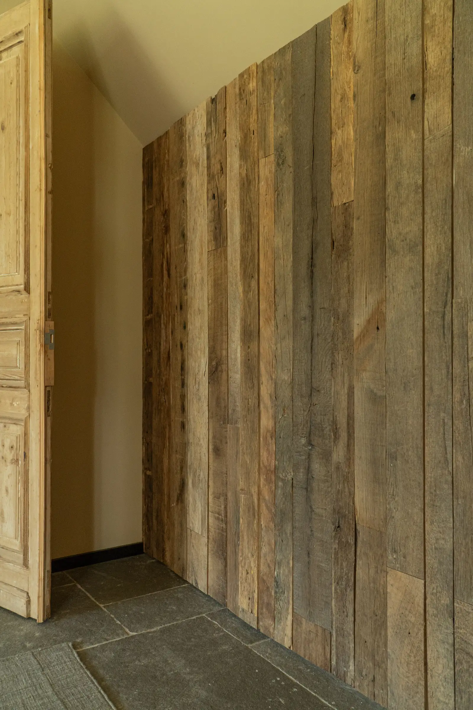 Sustainable reclaimed timber wall cladding with dark aged wood textures and character