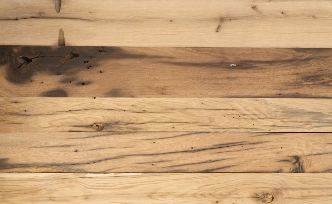 Rustic barnwood staircase cladding with reclaimed wood texture and aged appearance.