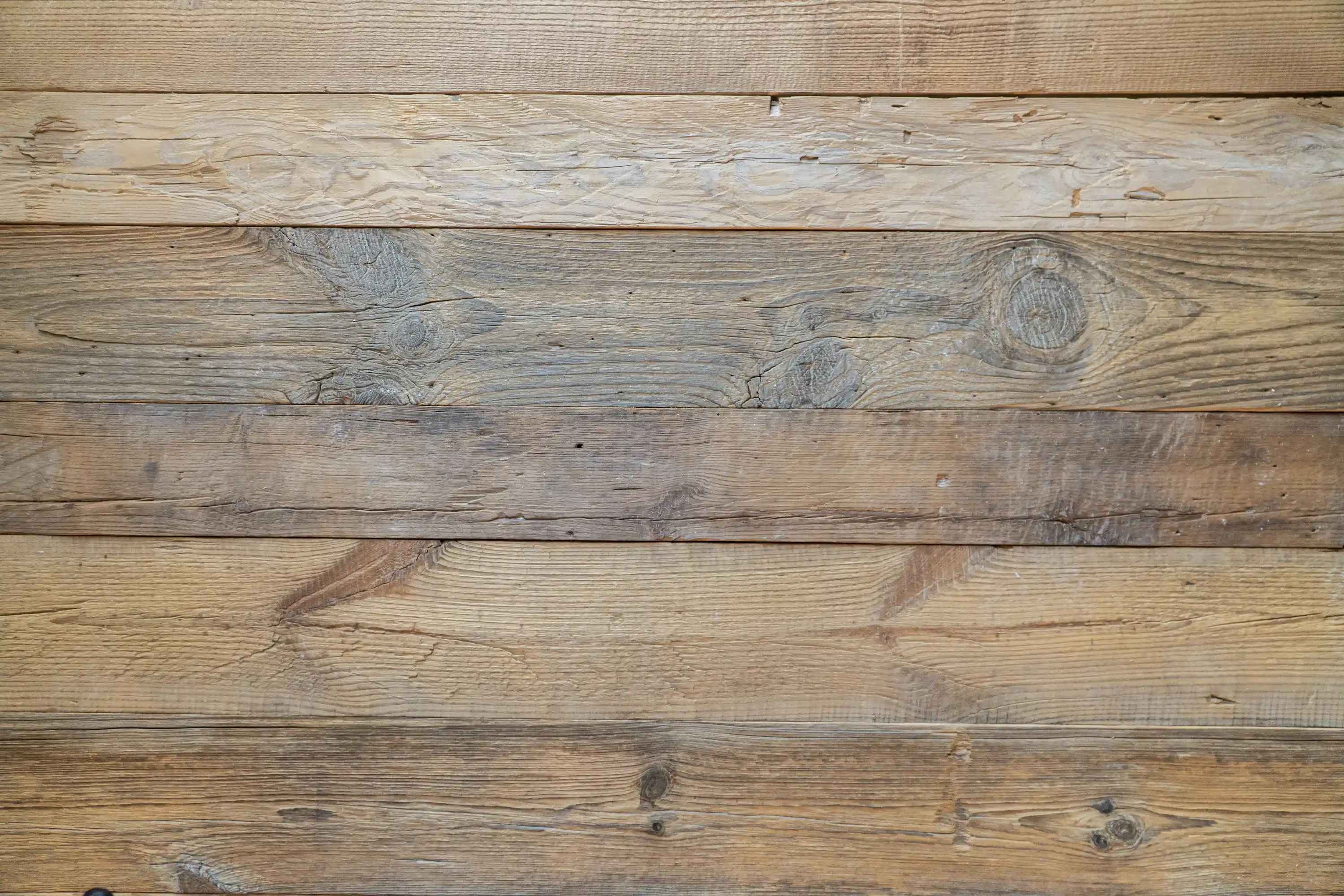Sustainable reclaimed wood paneling with aged wood surfaces and natural color variations