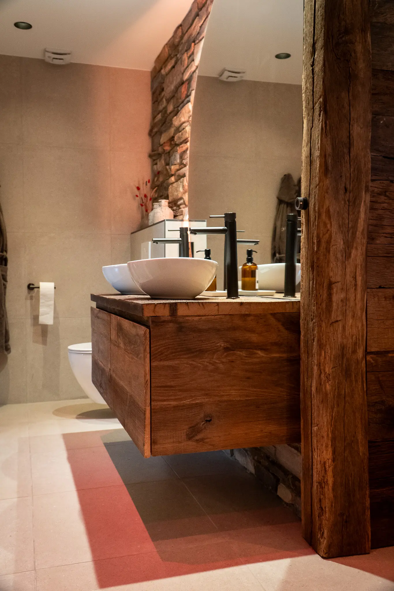Rustic reclaimed wood wall panels in a warm bathroom interior