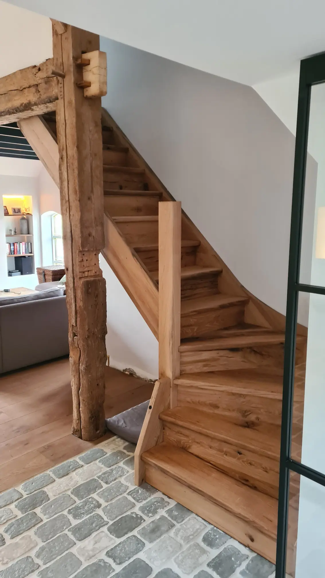 Reclaimed oak staircase with visible knots and historic wood character.