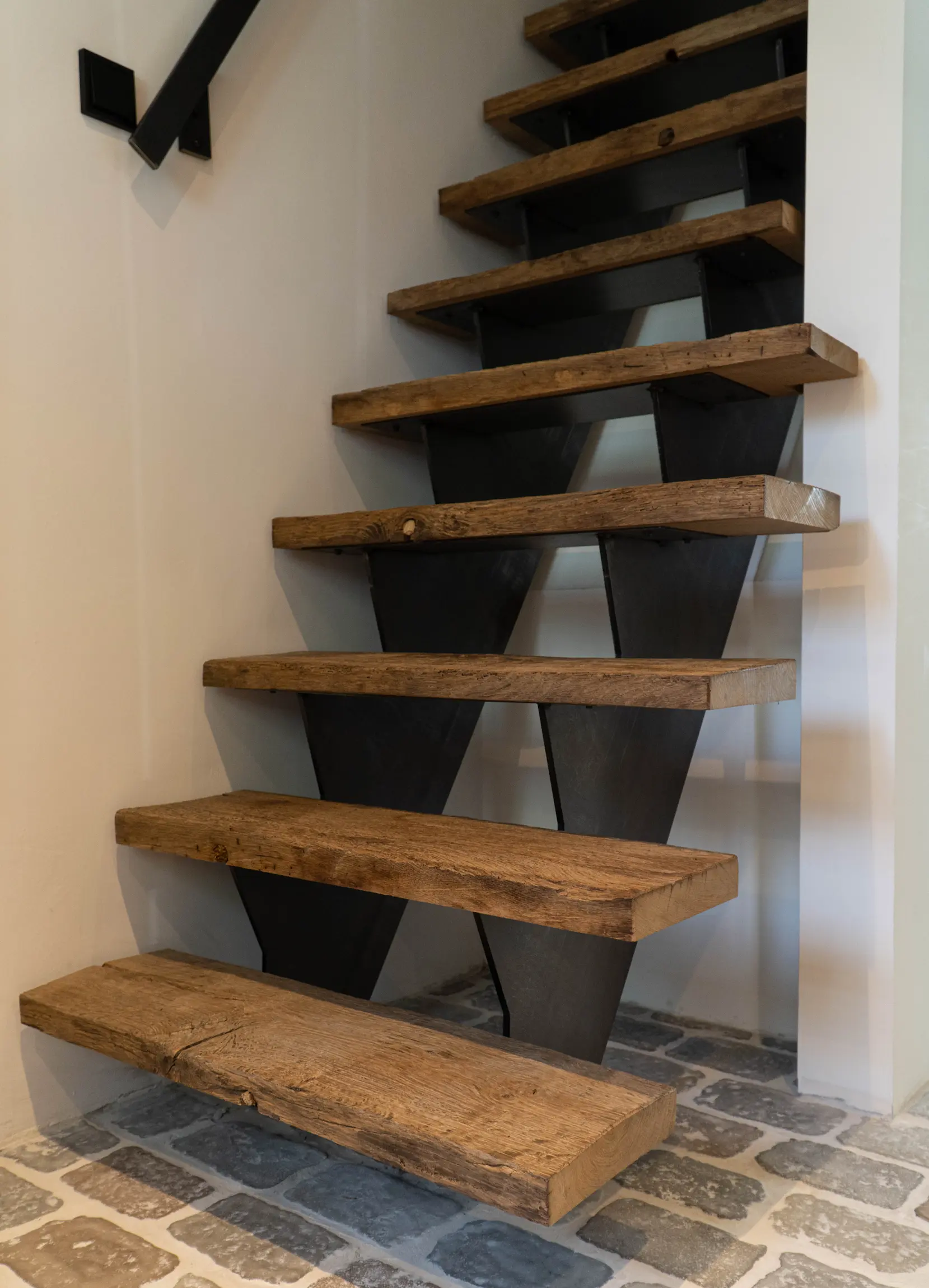 Custom reclaimed oak staircase featuring aged timber and natural grain details.