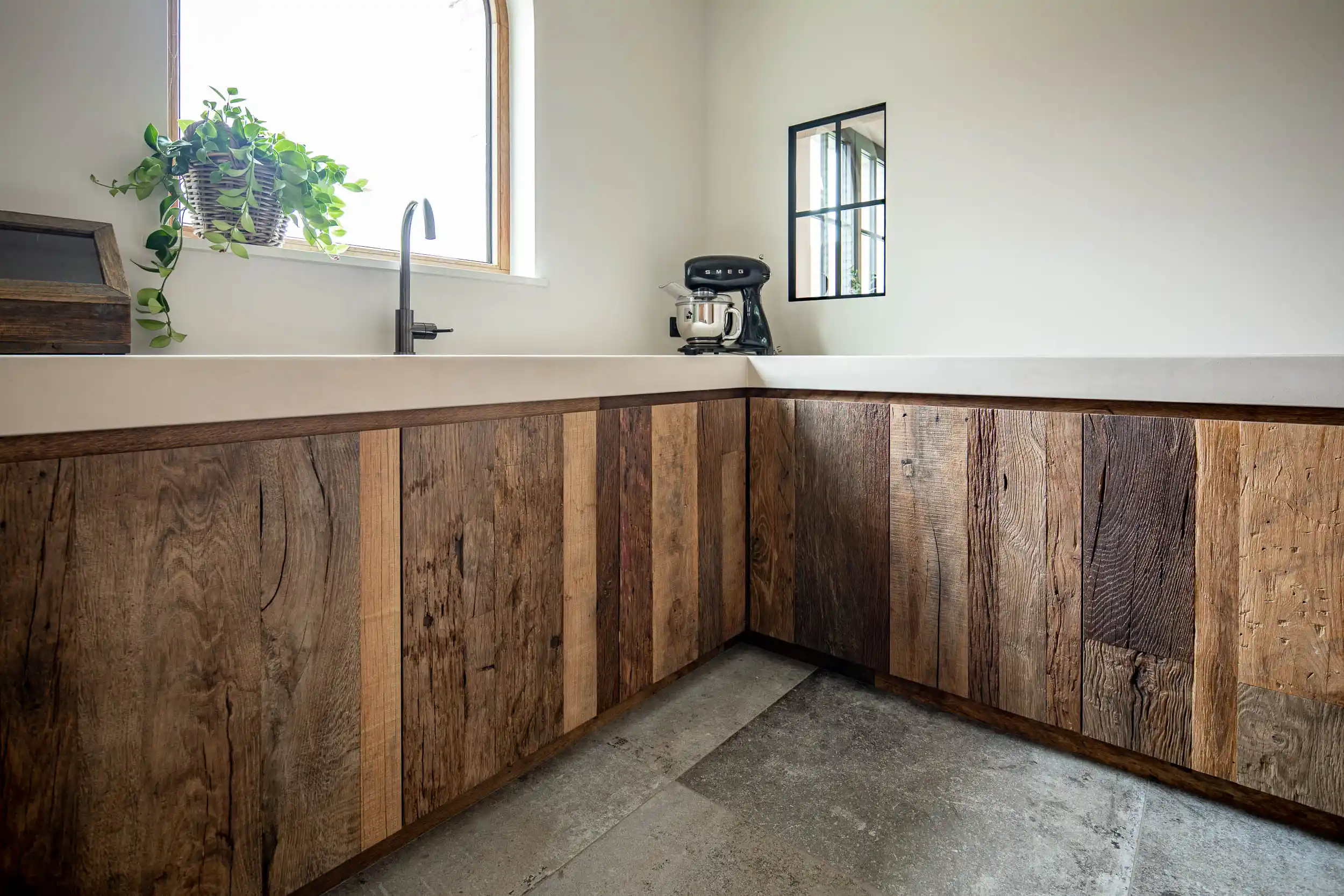 Modern kitchen finished with reclaimed plywood cabinetry and authentic weathered wood surfaces