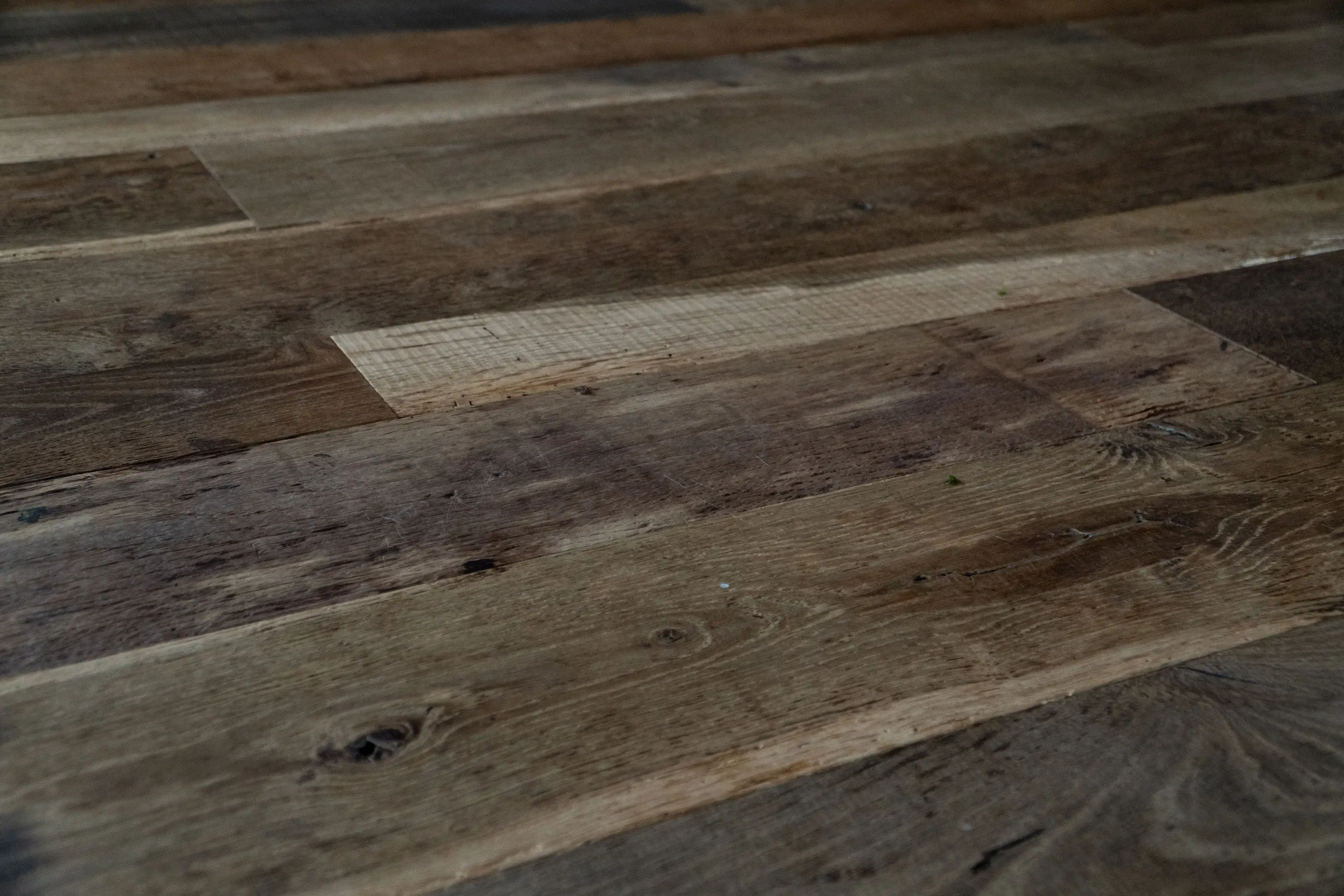 Dark reclaimed oak flooring with rich wood tones and authentic weathered textures