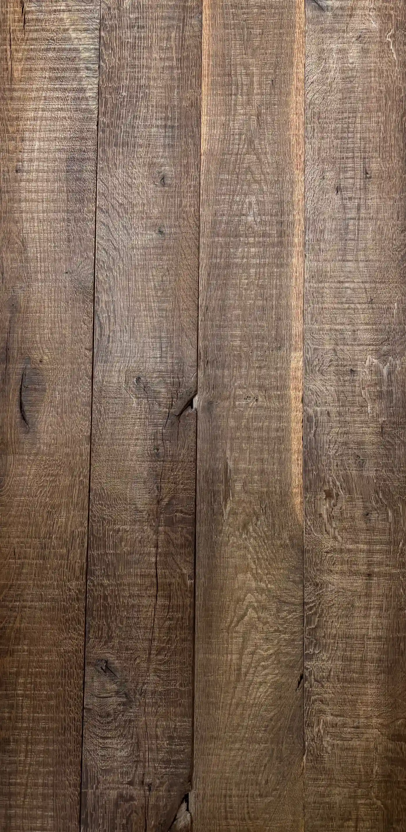 Weathered barnwood wall covering with visible grain patterns and natural imperfections.