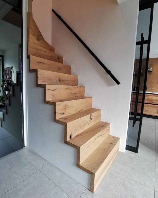 Bespoke reclaimed timber staircase crafted from historic wood with natural grain details.