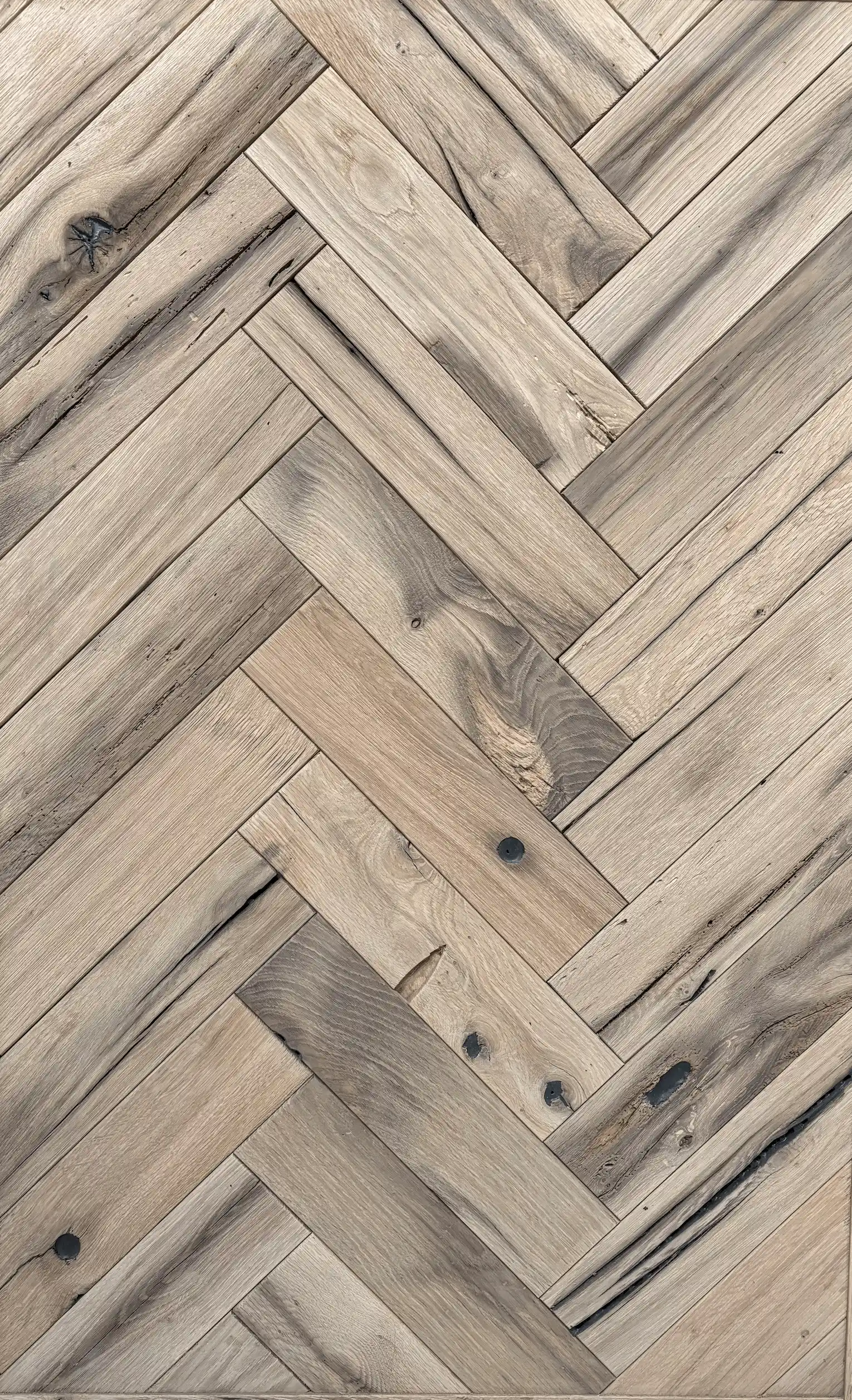 Rustic reclaimed oak floorboards with aged patina and authentic recycled wood textures