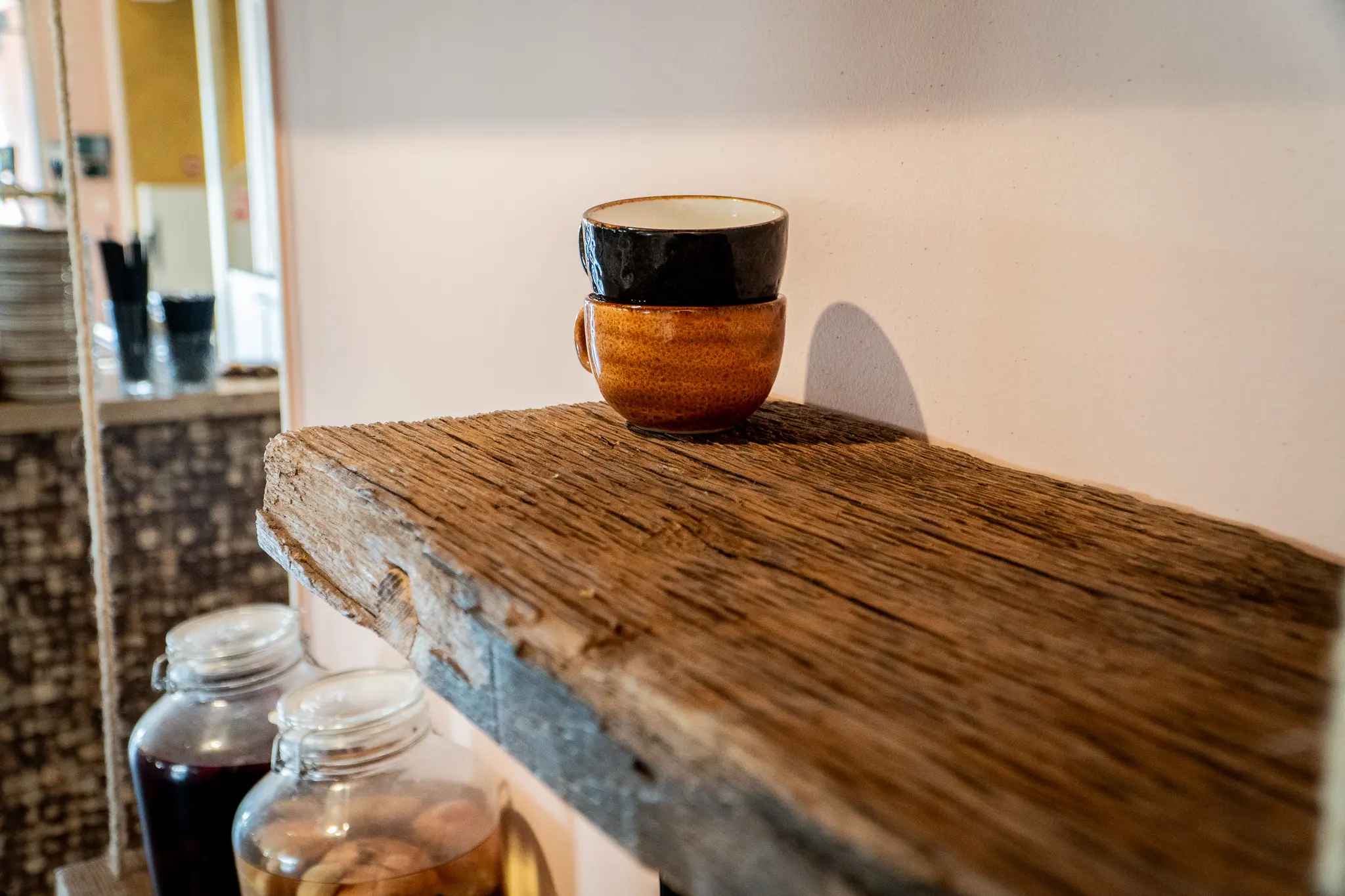 Decorative reclaimed wood floating shelves mounted on a smooth white wall with modern