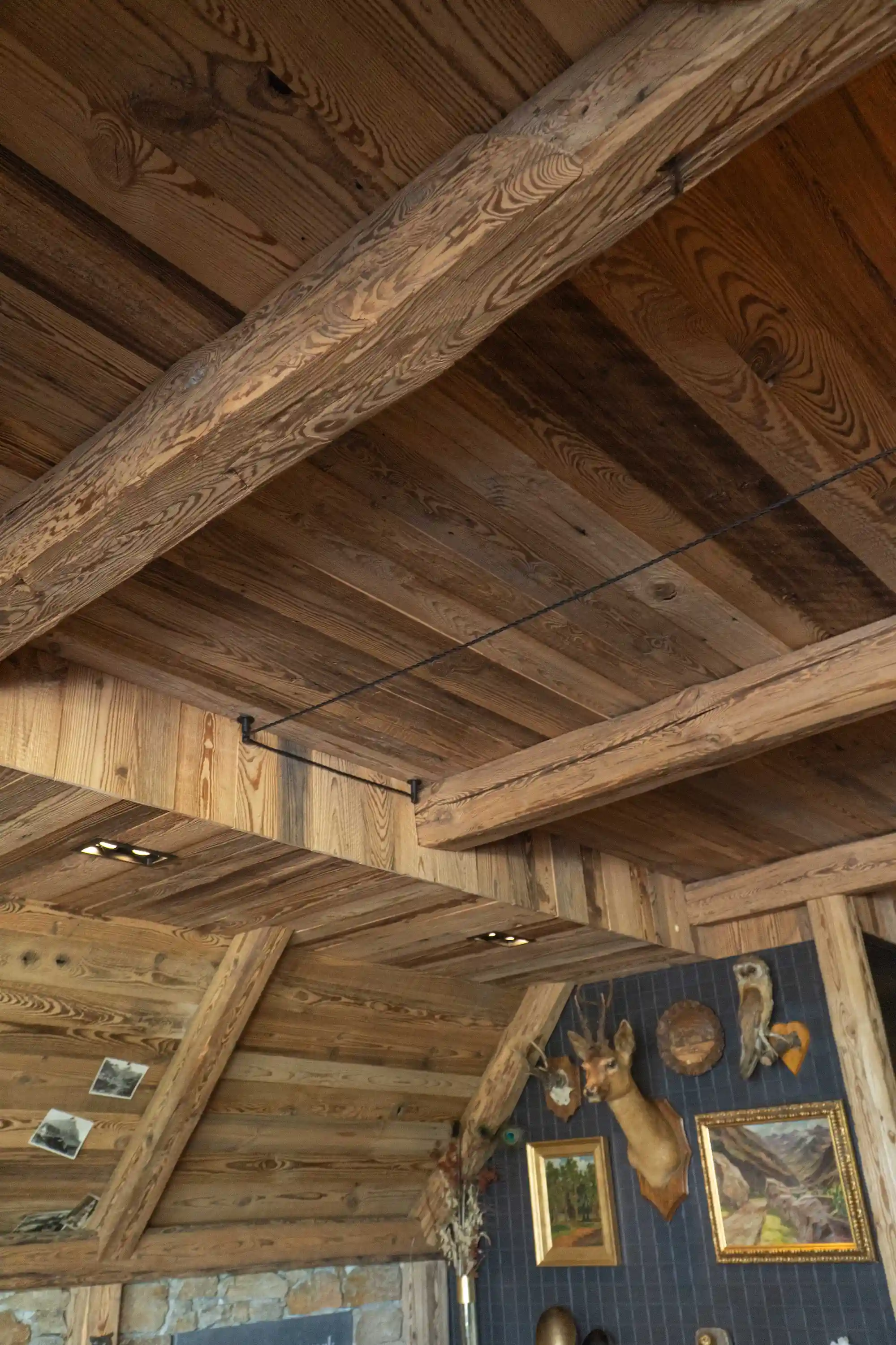Warm living space enhanced by reclaimed pine cladding.