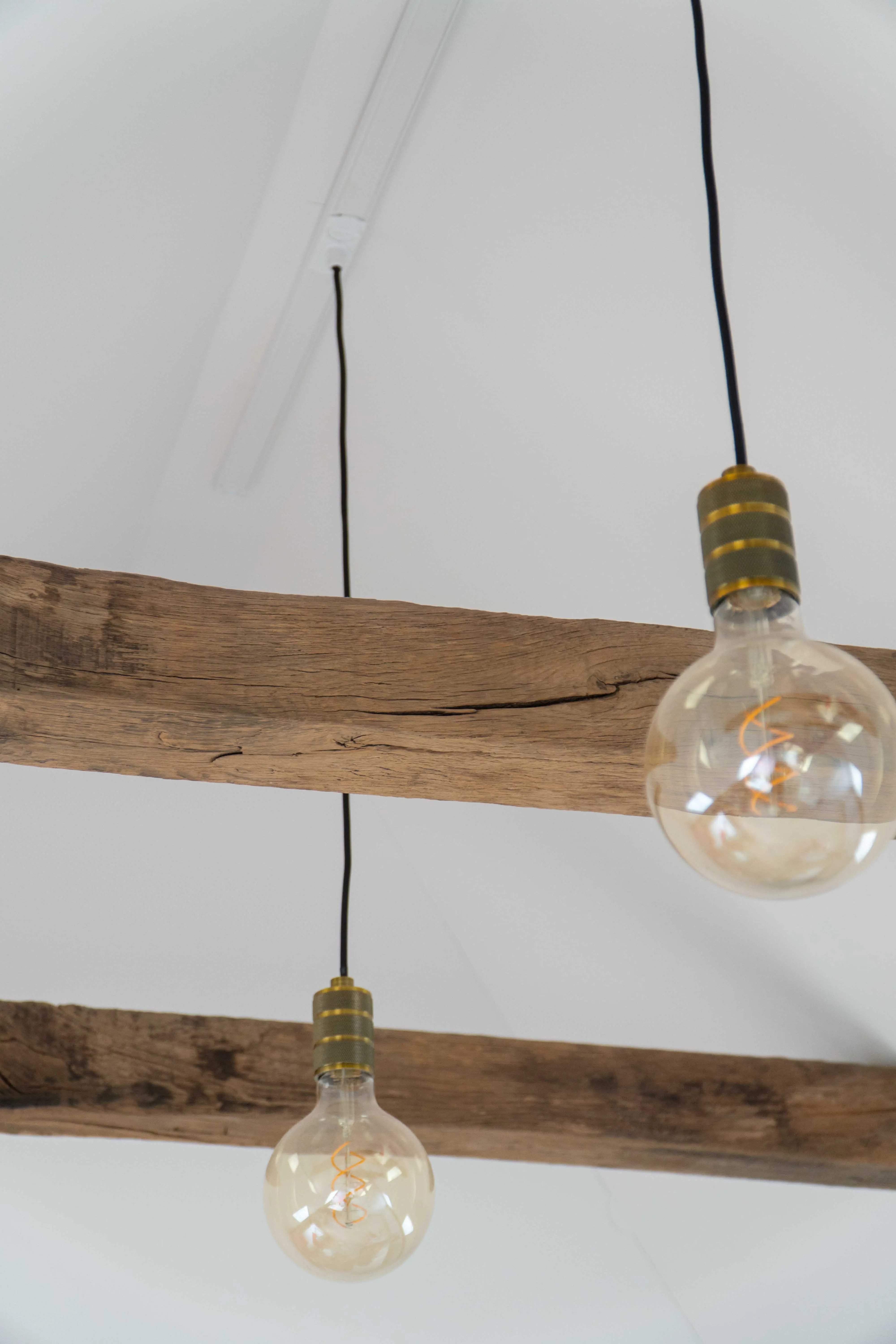 Authentic reclaimed oak ceiling beams with a weathered texture and natural character, adding warmth and timeless appeal to a contemporary interior.