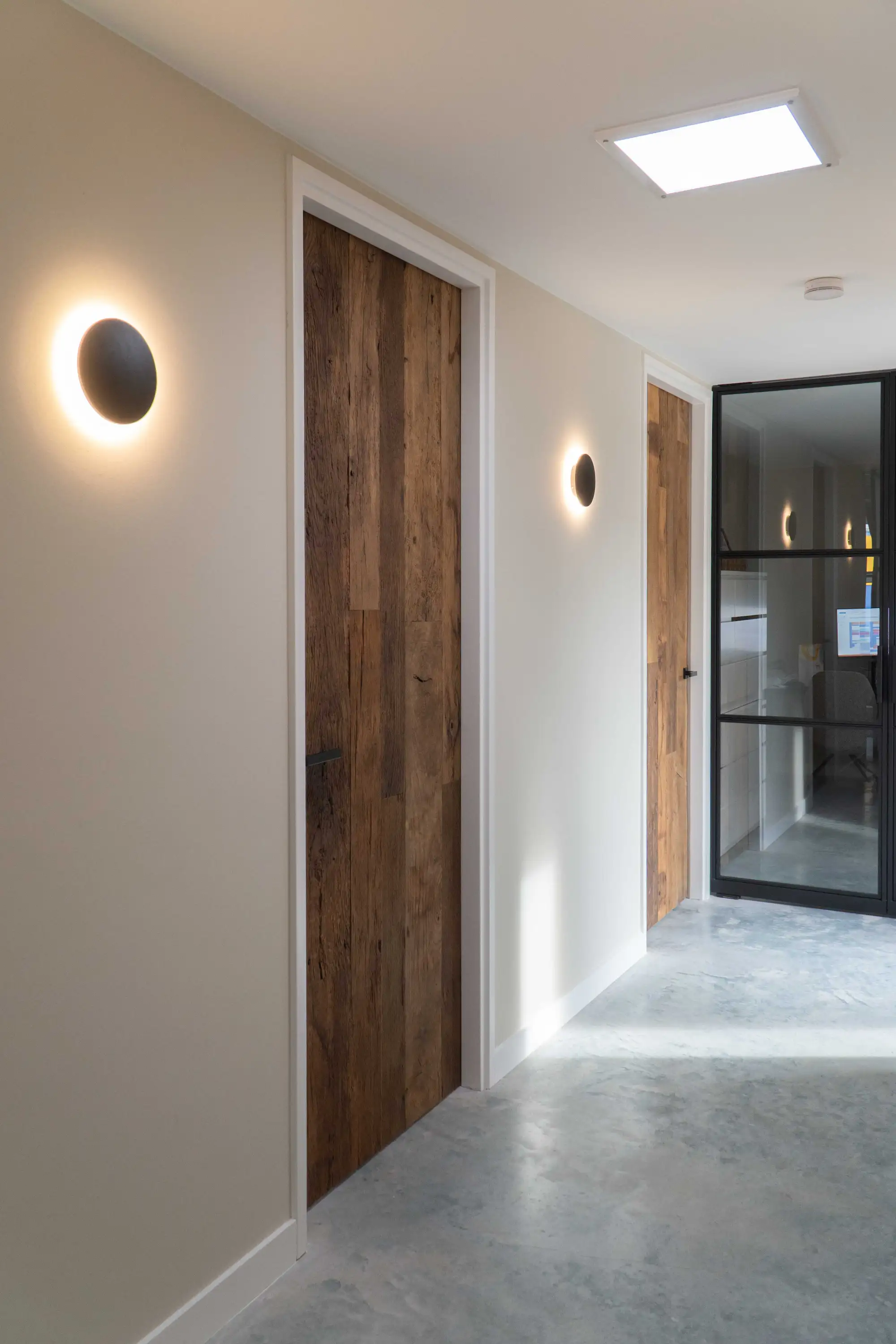 Solid reclaimed oak interior door featuring rich grain patterns, natural textures, and authentic character, beautifully integrated into a modern living space.