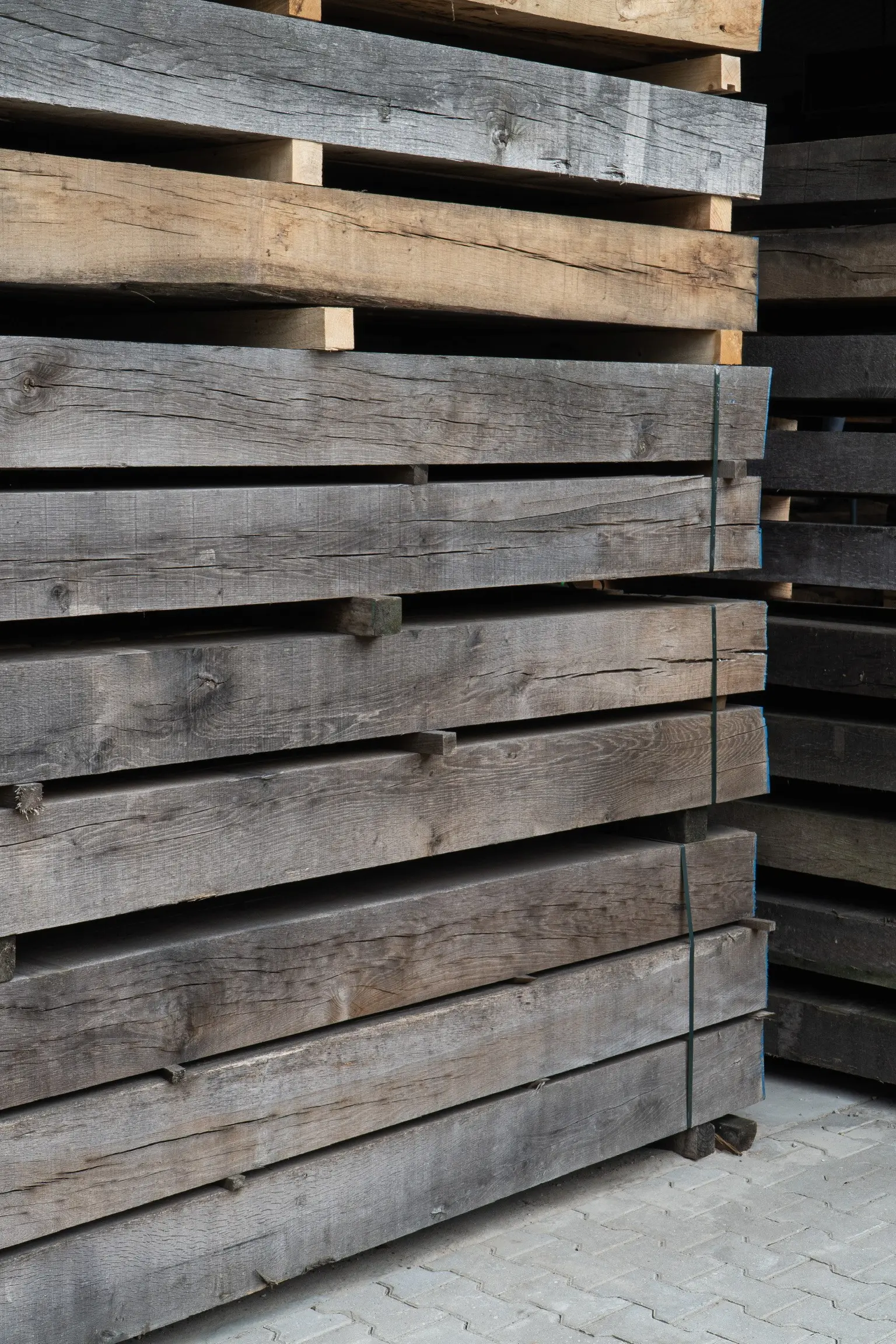 Air-dried oak beams stacked in storage