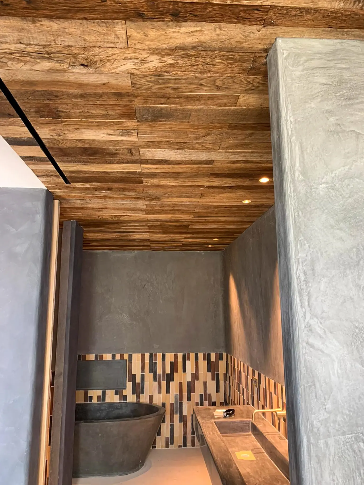 Characterful reclaimed wood ceiling cladding creating a warm and authentic atmosphere in a modern interior