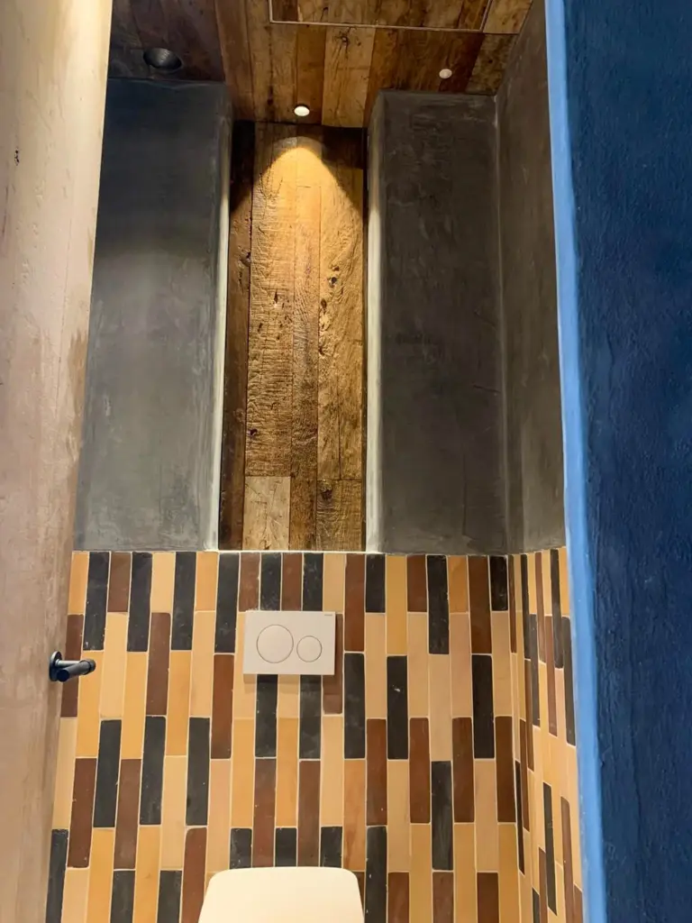 Reclaimed wood cladding used on the wall and ceiling of a modern interior, creating a warm and distinctive look