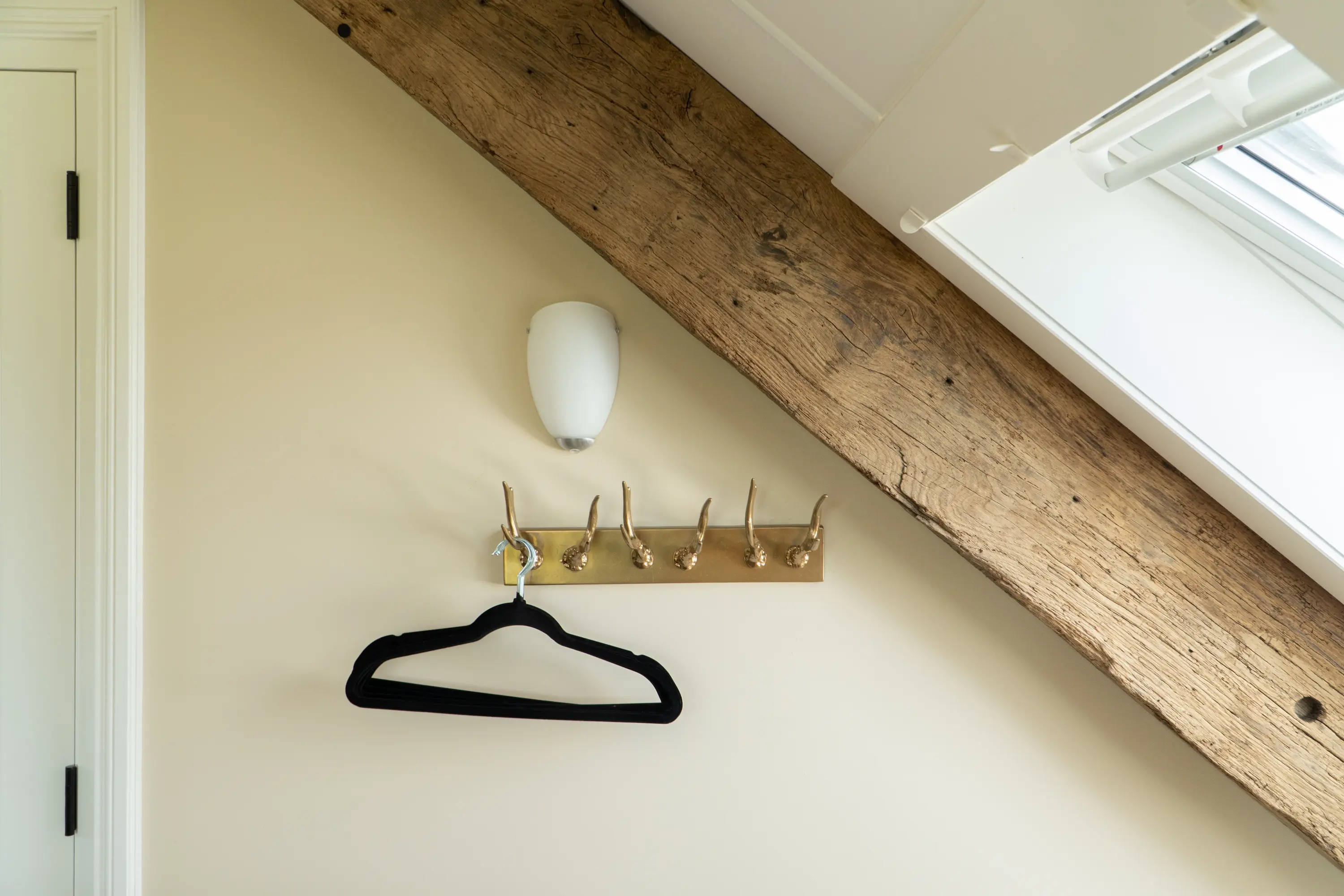 Authentic reclaimed oak beam used as a decorative feature in a bright interior