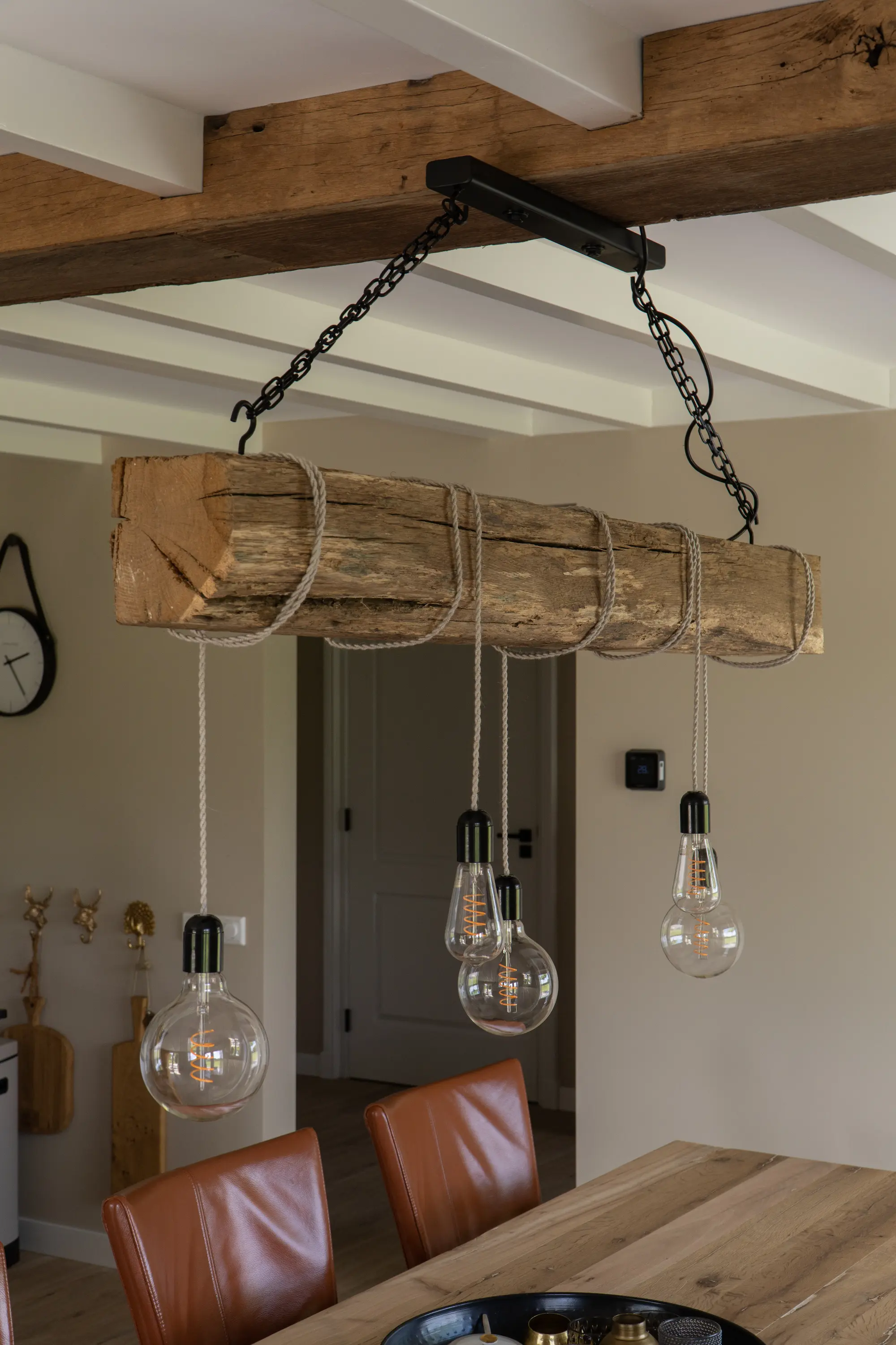 Authentic reclaimed oak beams used as a decorative ceiling feature above a dining area, adding warmth and character to the interior
