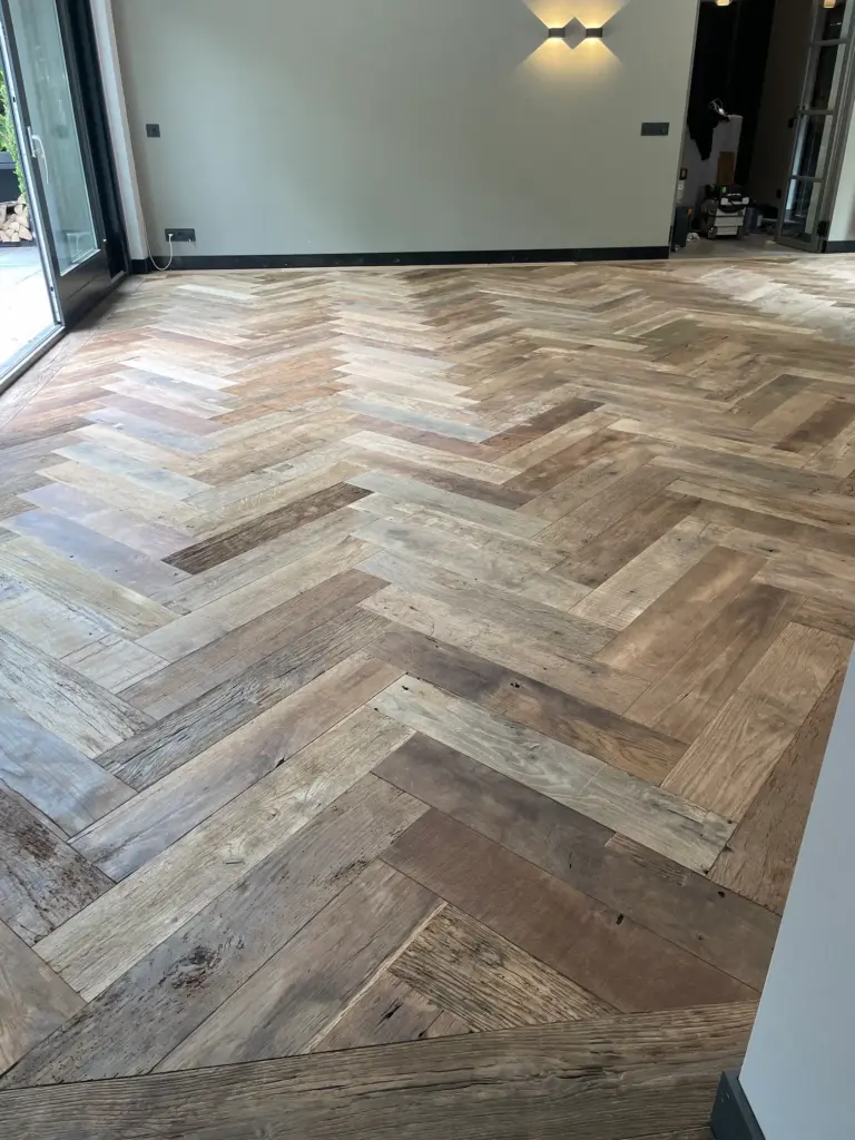 Reclaimed oak herringbone floor in a modern interior with natural colour variations and a warm appearance
