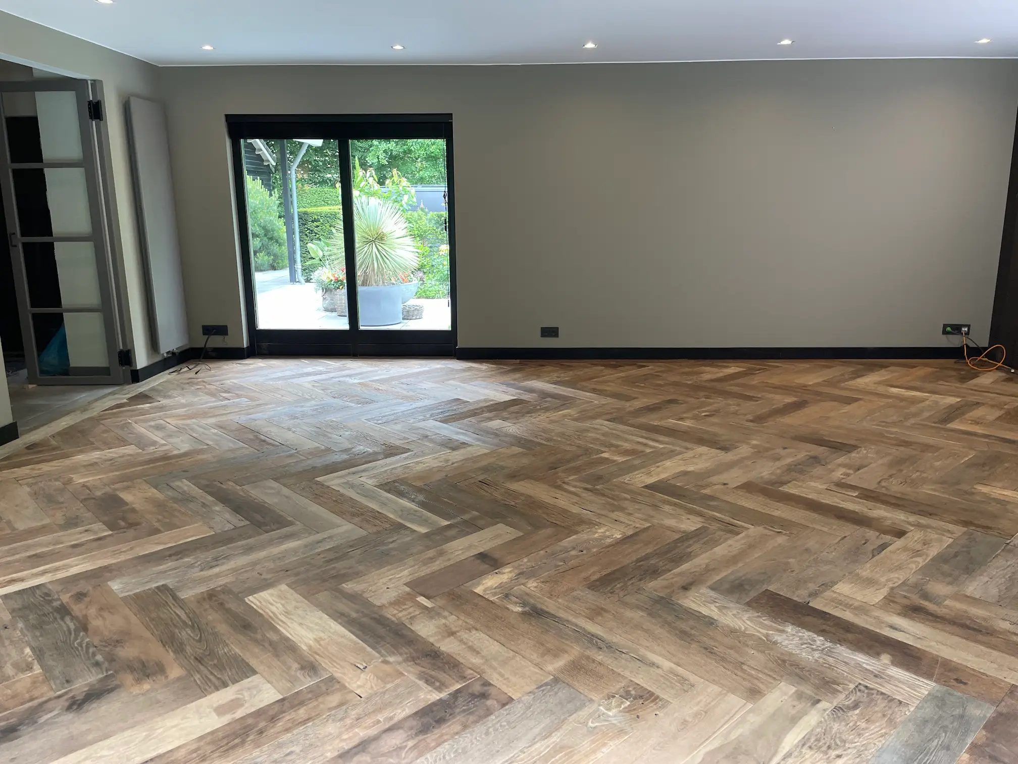 Reclaimed oak herringbone floor in a spacious interior in Zeeland with a warm, natural appearance
