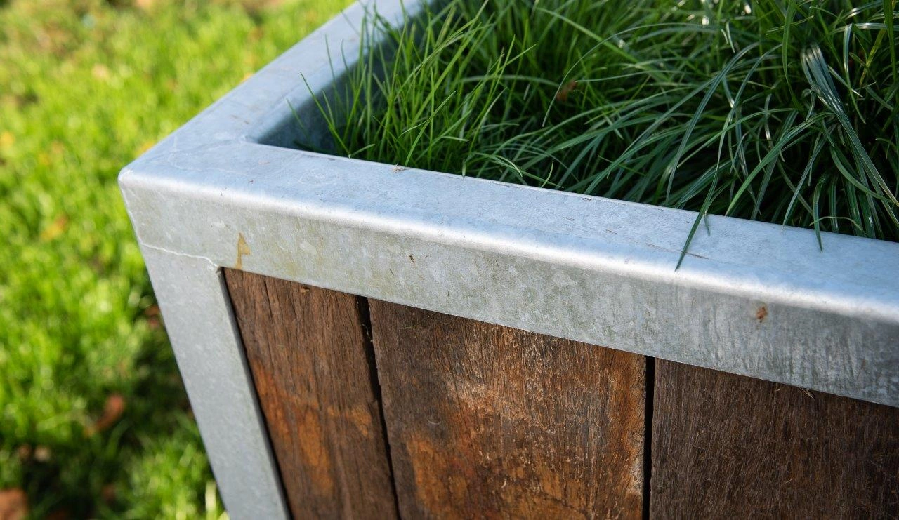 Close-up of reclaimed Azobé ship planks in a steel planter filled with greenery