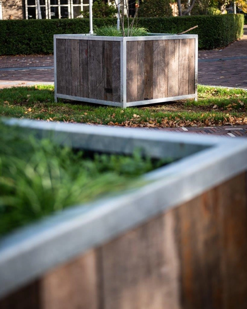 Reclaimed Azobé ship plank planter in a landscaped park in Den Helder