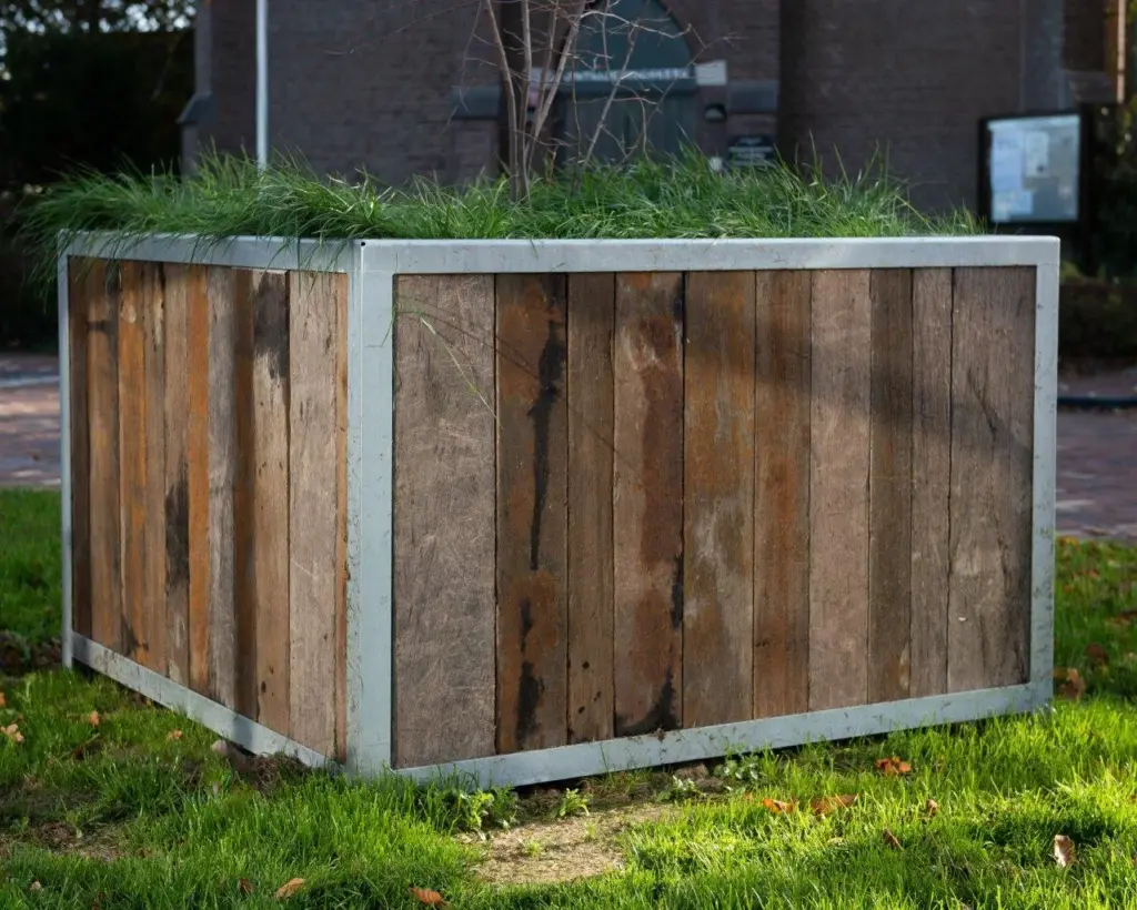 Large outdoor planter made from reclaimed Azobé ship planks in a park in Den Helder