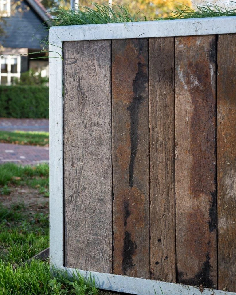 Close-up of reclaimed Azobé ship planks used in a steel outdoor planter